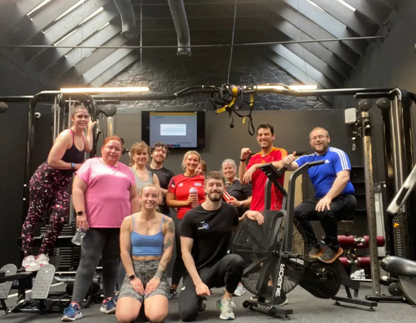 Members of a BodyMechanics class together on the gym floor