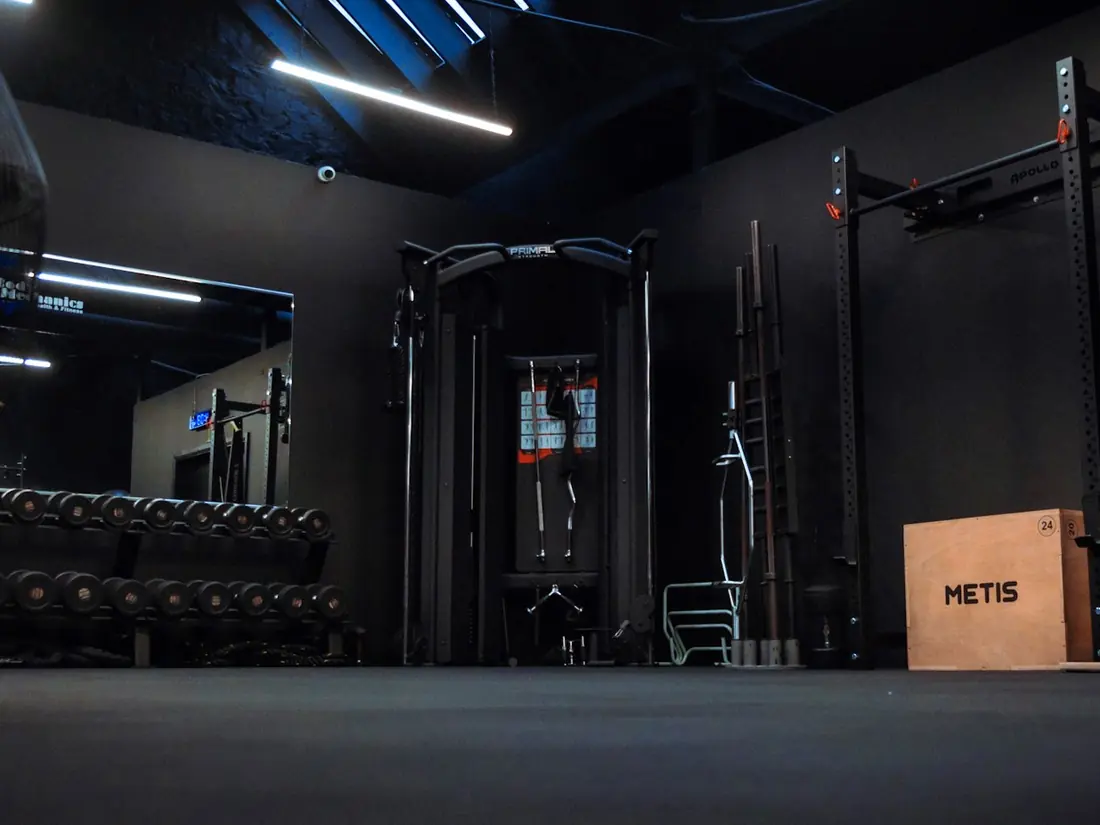 The strength floor at BodyMechanics with the rack, cable station and dumbbells