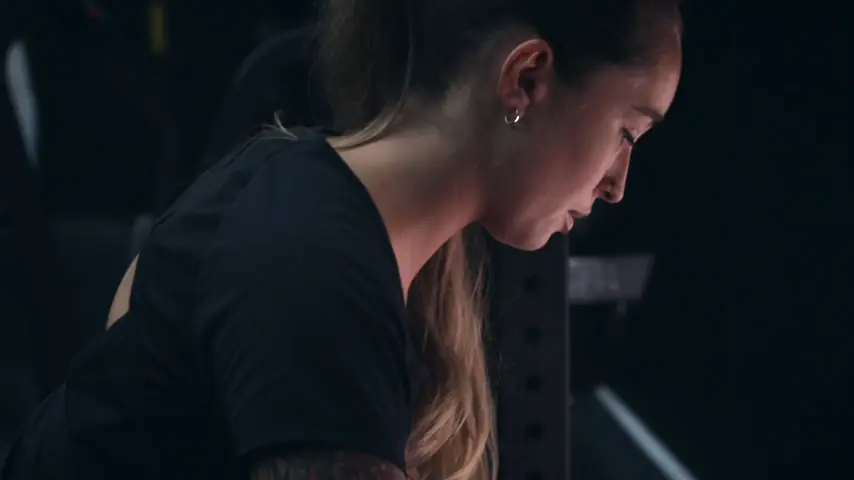 A member setting up for a deadlift on the gym floor